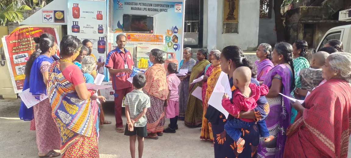Sakthi Gas staff explaining LPG safety to a group of customers beside the HPCL awareness van
